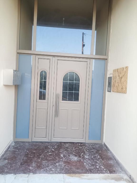 a pair of doors in a room with at Proche CENTRE VILLE - BALCON - VUE - Calme in Igoumenitsa