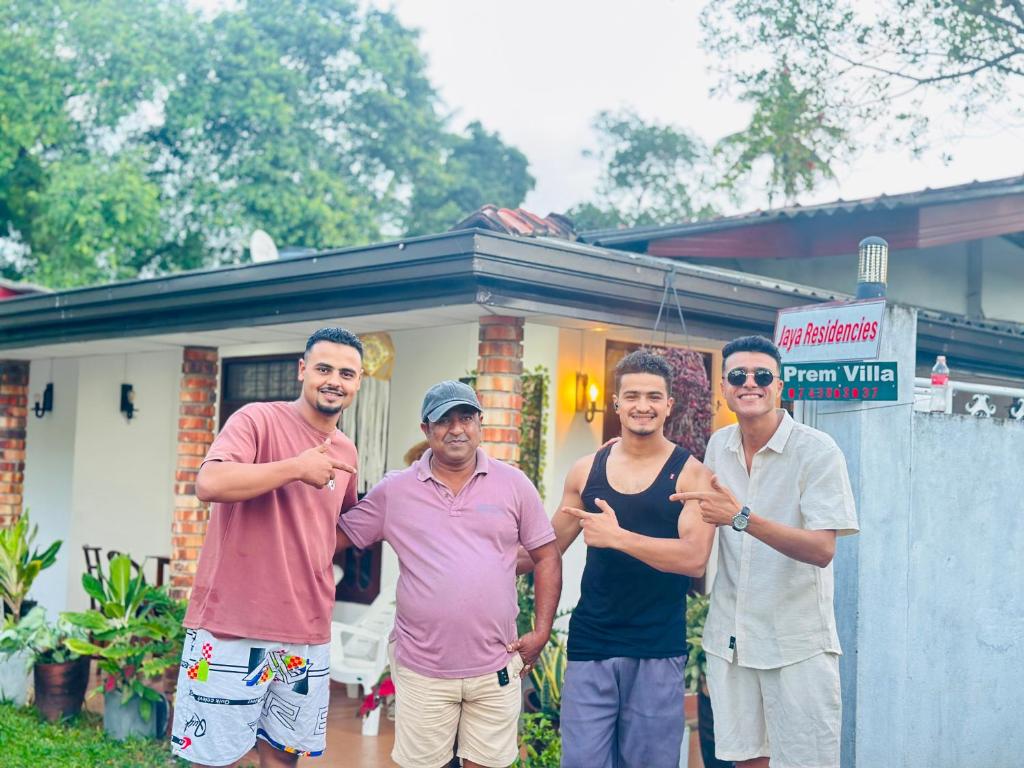a group of men standing in front of a house at Jaya Residence - Near Airport in Negombo