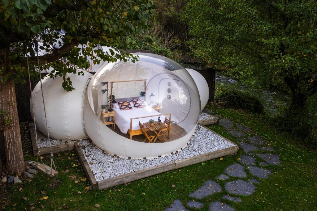 a glass dome house with a bed in it at Burbujas a las puertas de Andorra in Argolell