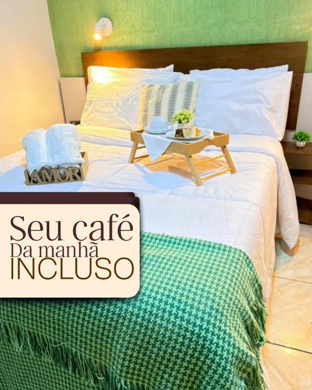 a large bed with a table on top of it at Cantinho Aconchegante in Volta Redonda