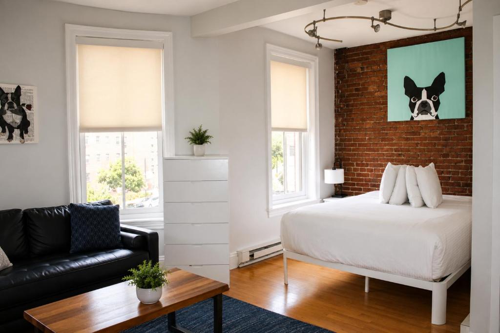 a bedroom with a bed and a brick wall at Charming Studio in Boston Brownstone, C.Ave#5 in Boston