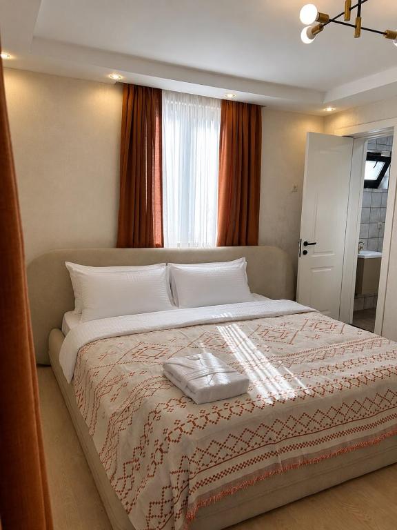 a bedroom with a large bed with white pillows at Cherry Guesthouse in Tsalka