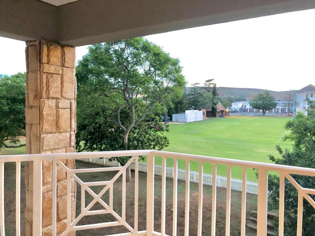 a balcony with a view of a golf course at Beautiful 3 bedroom flat in Grahamstown