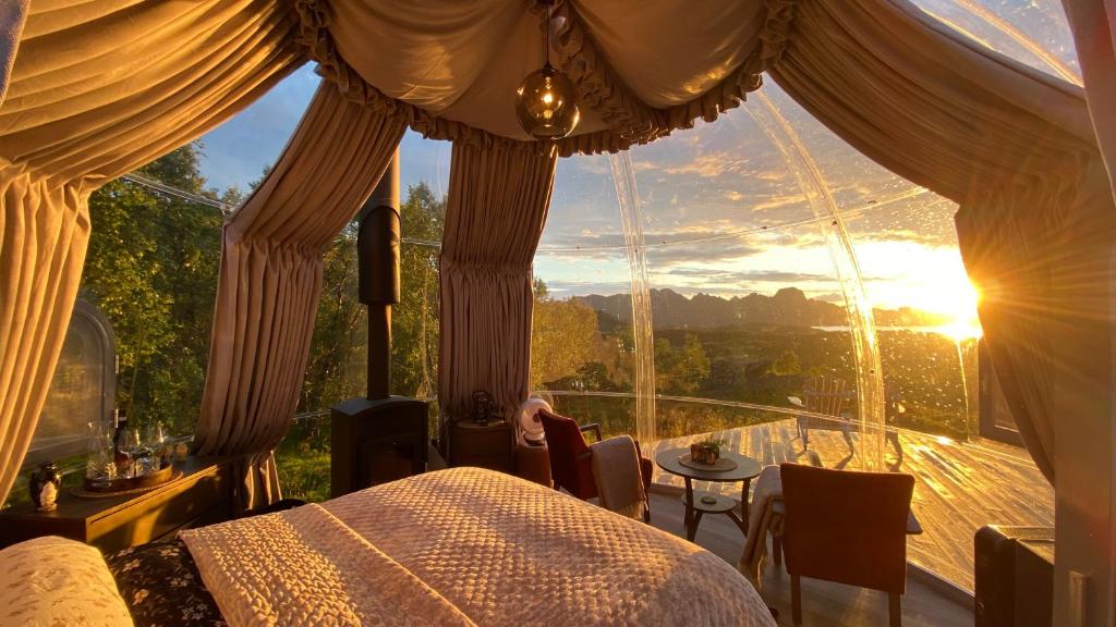 a bedroom with a bed and a large window at Hjertero - Hide Away Suite in Sortland