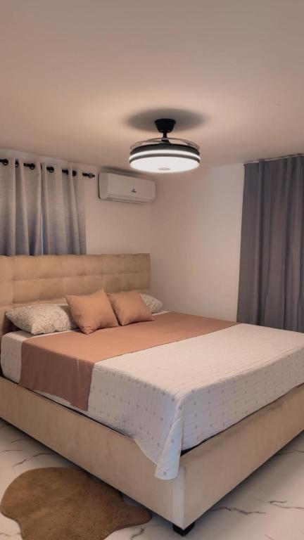 a bedroom with a large bed in a room at Carrasco D in Nagua