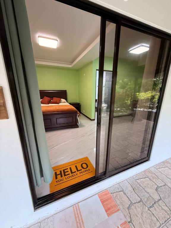 a view of a bedroom through a sliding glass door at Hospedaje Río Palomo in Orosí