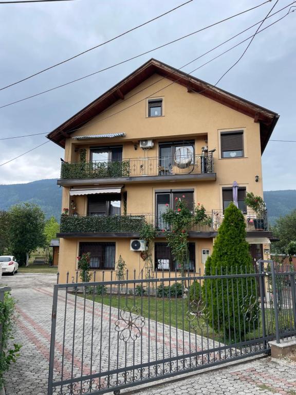 a house with a fence in front of it at Restful Garden Apartmants in Sarajevo