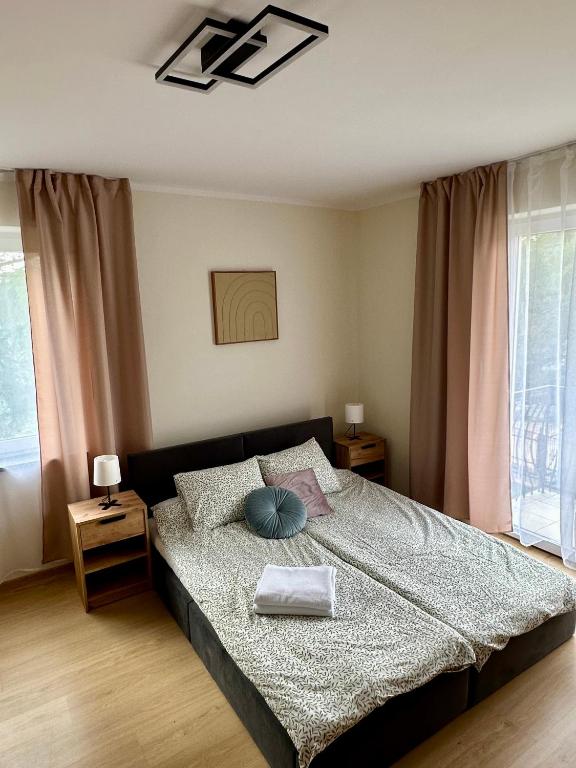 a bedroom with a bed with a blue pillow on it at Nad Wadągiem in Kieźliny