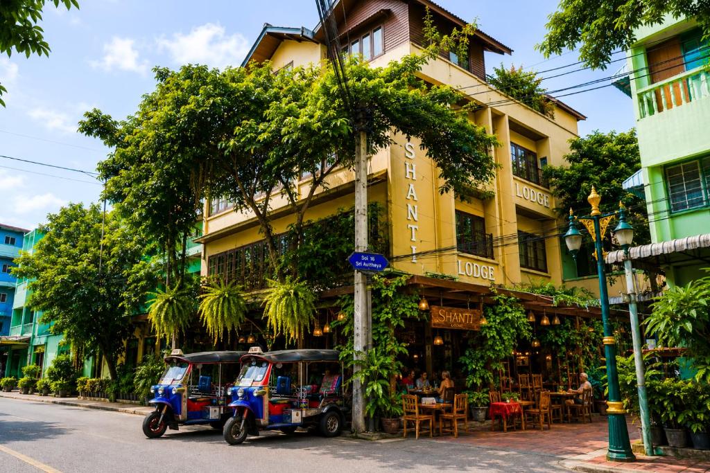a small vehicle parked in front of a building at Shanti Lodge Bangkok in Bangkok