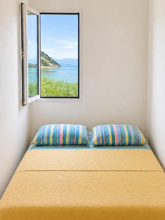 a bed in a room with a window at Apartment Lake Oasis ''Oko'' in Krnjice