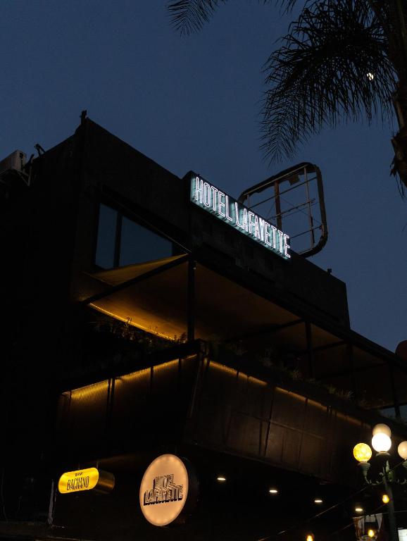 a sign on top of a building at night at Hotel Boutique Lafayette Tijuana in Tijuana
