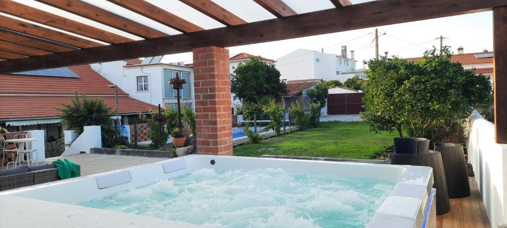 a hot tub on the patio of a house at Casa Adega Do Mosteiro - Turismo Rural in Caldas da Rainha