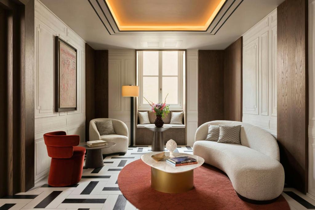 a living room with two chairs and a table at Hotel Urbana, a Tribute Portfolio Hotel in Rome