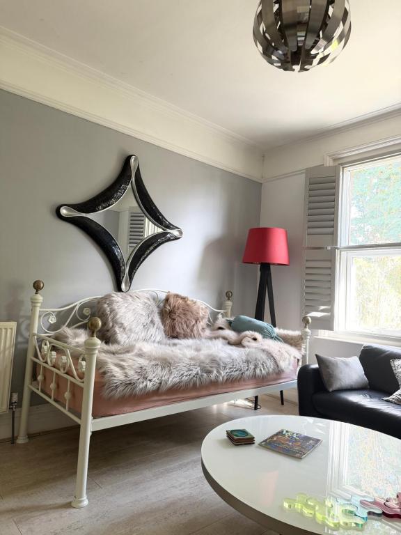 a bedroom with a bed with a dog laying on it at Bournemouth. Private Self Contained space. in Bournemouth