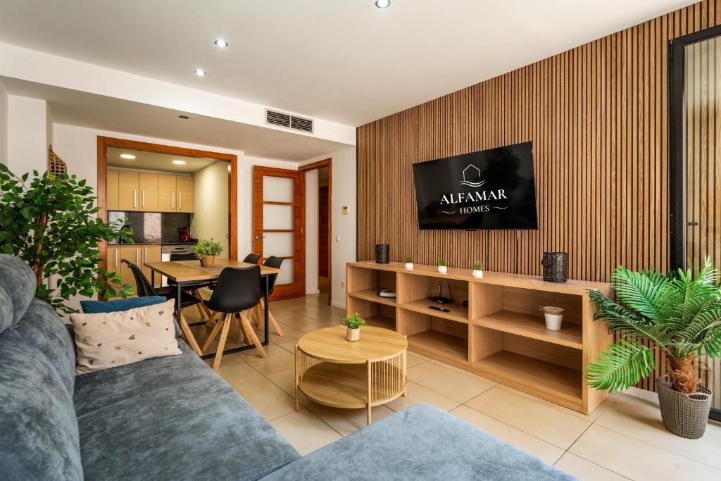 a living room with a couch and a table at Hanami Suite in Lloret de Mar