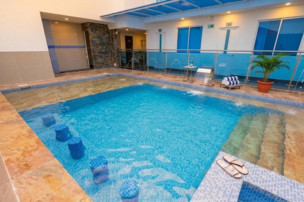 a large swimming pool with sandals in a building at Ocean Blue Beach in San Andrés
