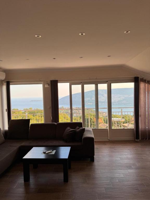 a living room with a couch and a table at Vila Denda Herceg Novi in Herceg-Novi