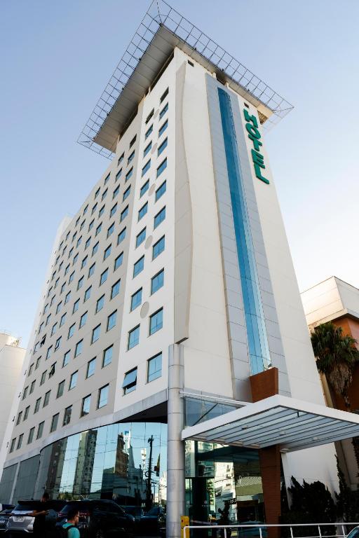 a building with the name of a hotel at Firenze Business Hotel in Palhoça