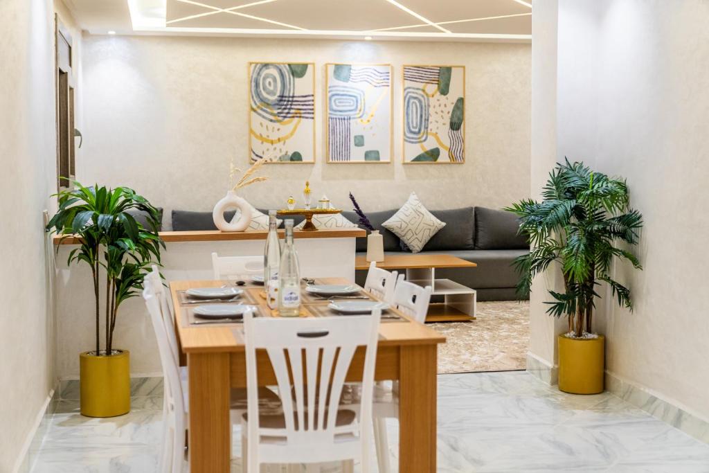 a dining room and living room with a table and chairs at Lagoon House Dakhla in Dakhla
