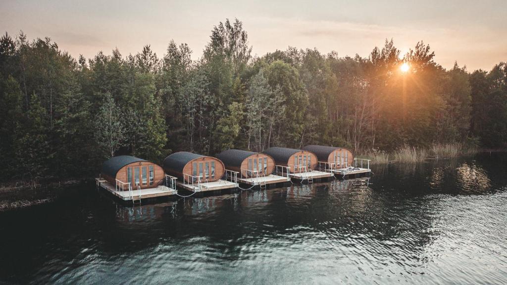 a row of domes on a dock in the water at Paekalda Holiday Centre in Rummu