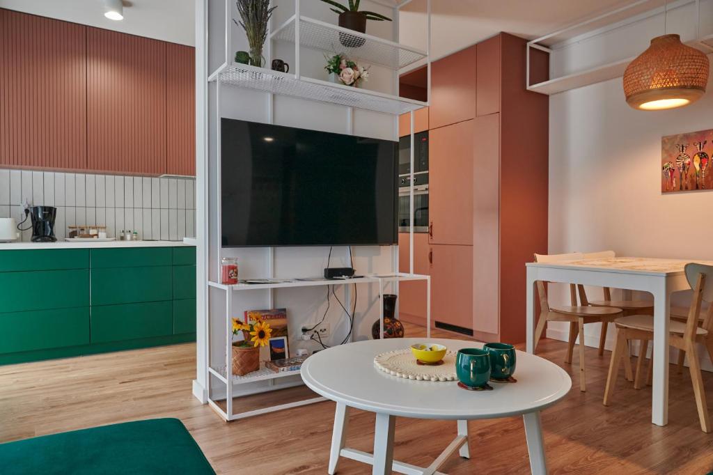 a living room with a tv and a table at Apartament Kaskady75 in Łańcut