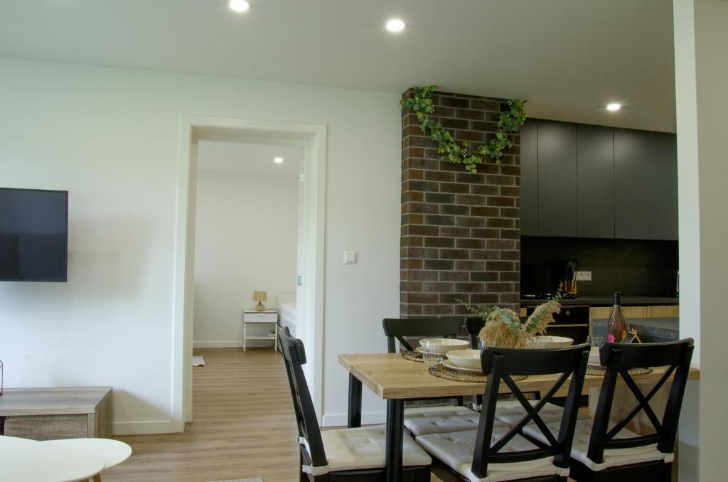 a kitchen and dining room with a table and chairs at Manor in Stará Lesná