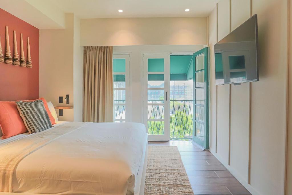 a bedroom with a large bed and a balcony at Casa México in Mexico City