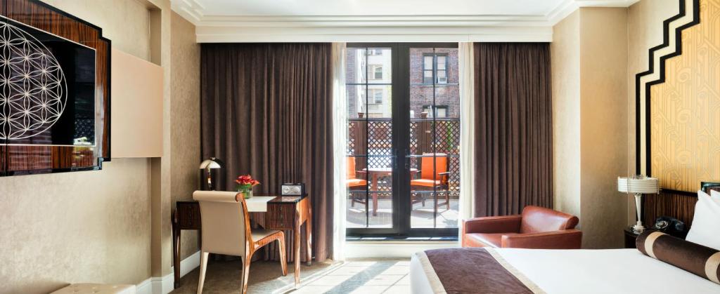 a hotel room with a bed and a desk with a chair at Walker Hotel Greenwich Village in New York