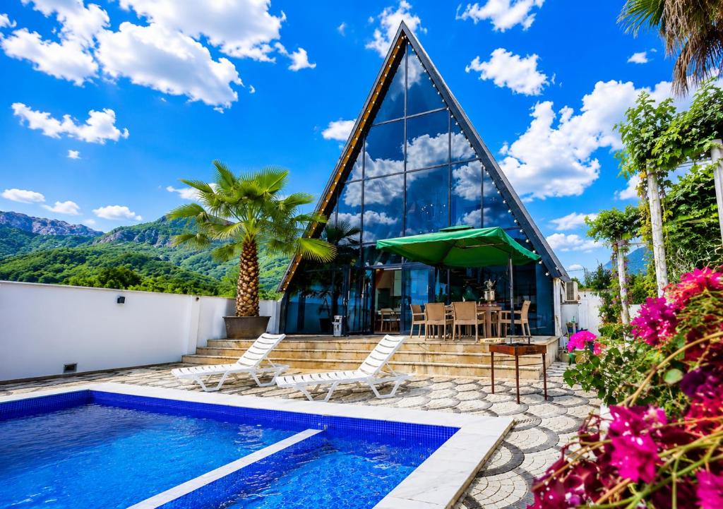 a villa with a swimming pool and a house at ES Dream A-Frame Cabin in Gabala