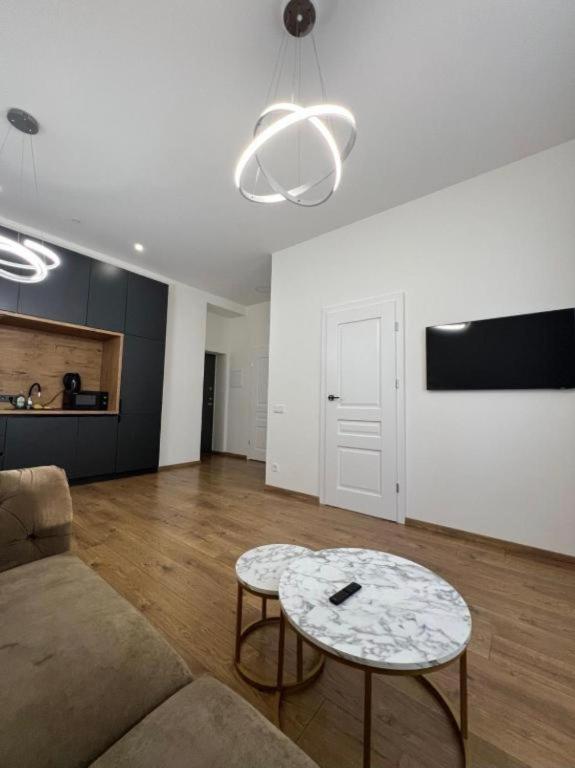 a living room with a couch and a table at Modern apartment in Klaipėda