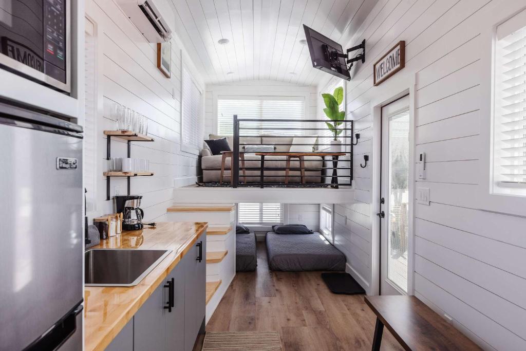 a tiny house with a kitchen and a bunk bed at Zion Basecamp Private Hot Tub Near Trails in Apple Valley