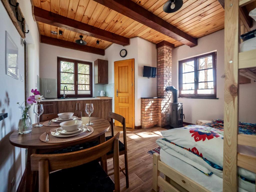 a kitchen and dining room with a table in a room at Domek 2-3 osobowy in Lejno