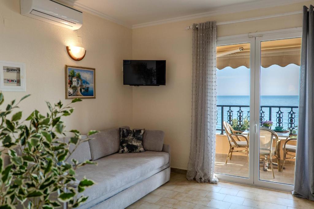 a living room with a couch and a view of the ocean at Corfu Glyfada Beach Apartment 40 in Glyfada