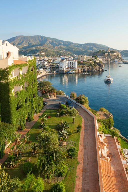 a view of a body of water with buildings and trees at Hotel Carasco in Lipari