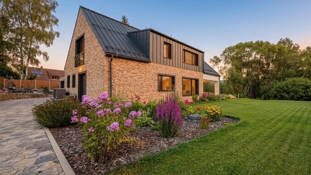 a brick house with flowers in a yard at Studio U Karolíny Nová Pec in Nová Pec