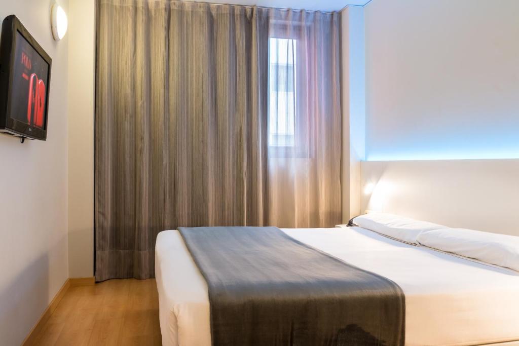 Cama o camas de una habitación en Vértice Roomspace