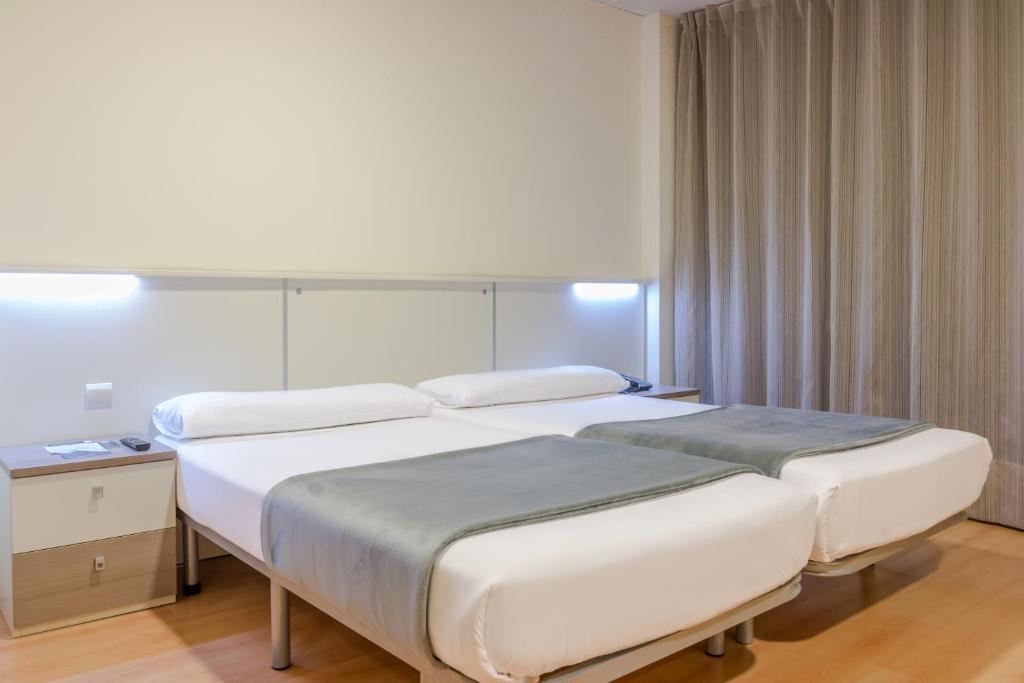 Posteľ alebo postele v izbe v ubytovaní Vértice Roomspace