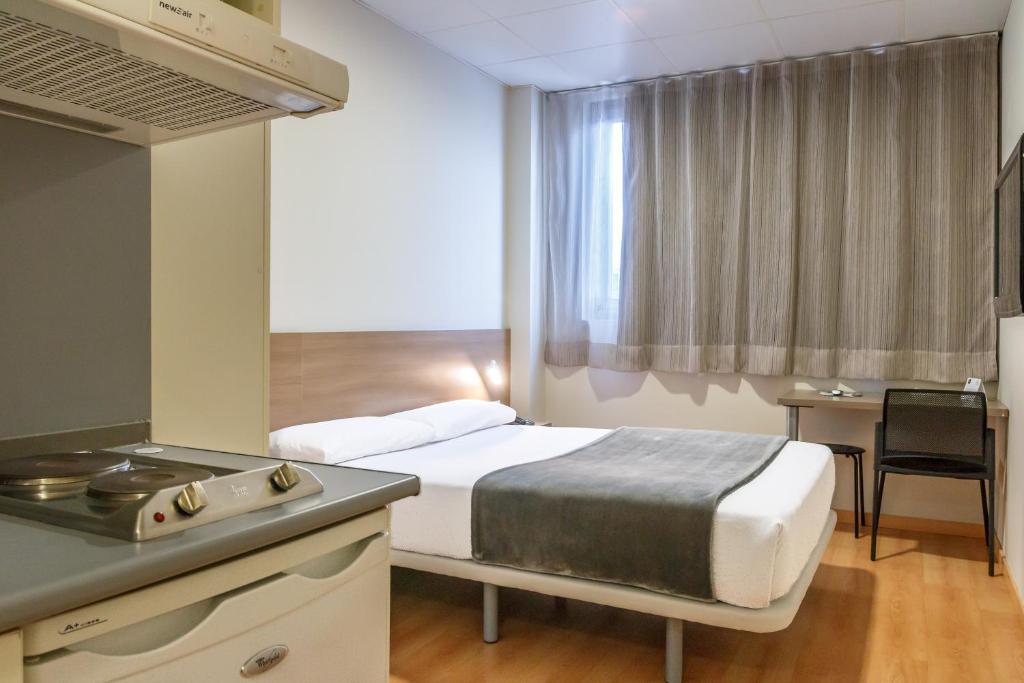Cama o camas de una habitación en Vértice Roomspace