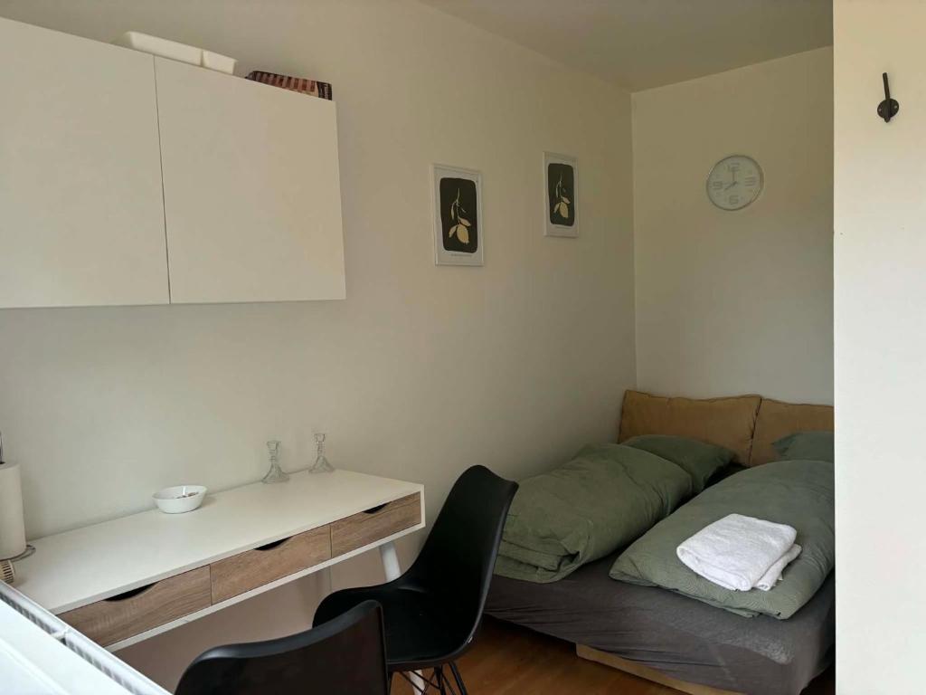 a bedroom with a bed and a table and chairs at Mølhøjvej lejlighed in Andrup