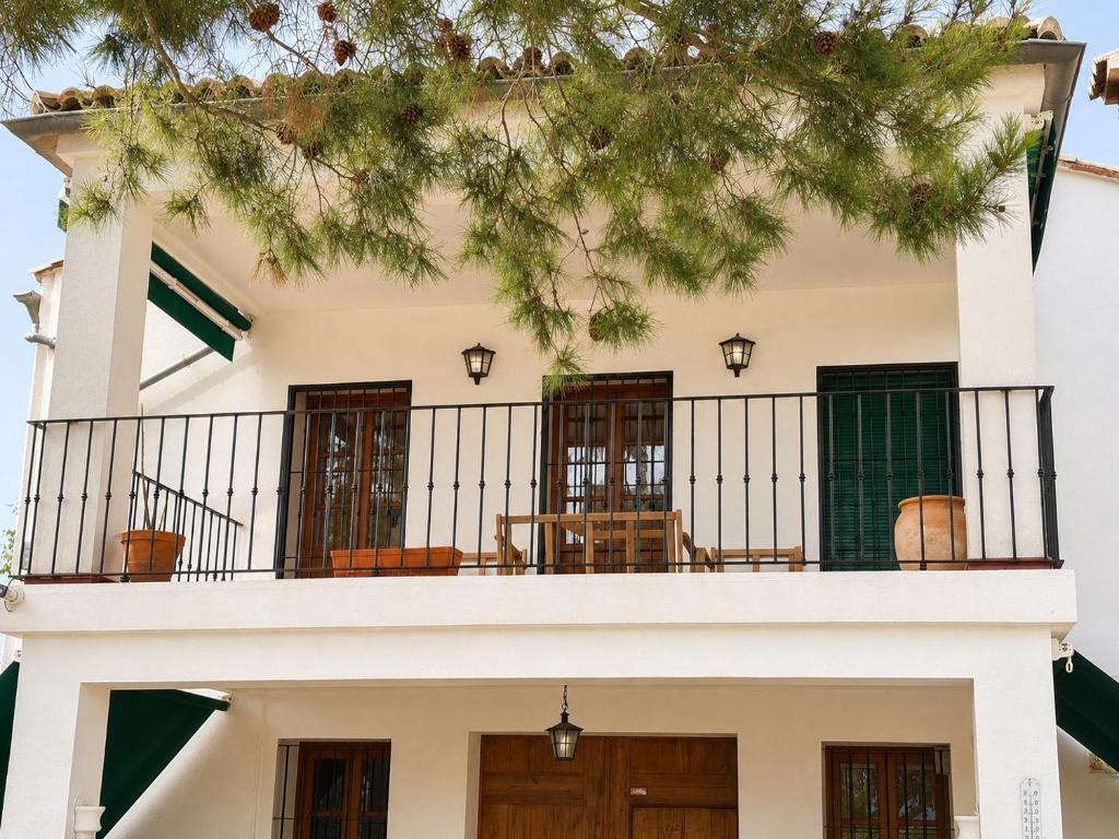 a building with a balcony with chairs on it at Casa Canciones in Alzira