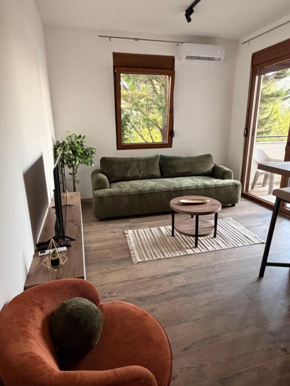 a living room with a couch and a table at Iva Apartment in Kumbor