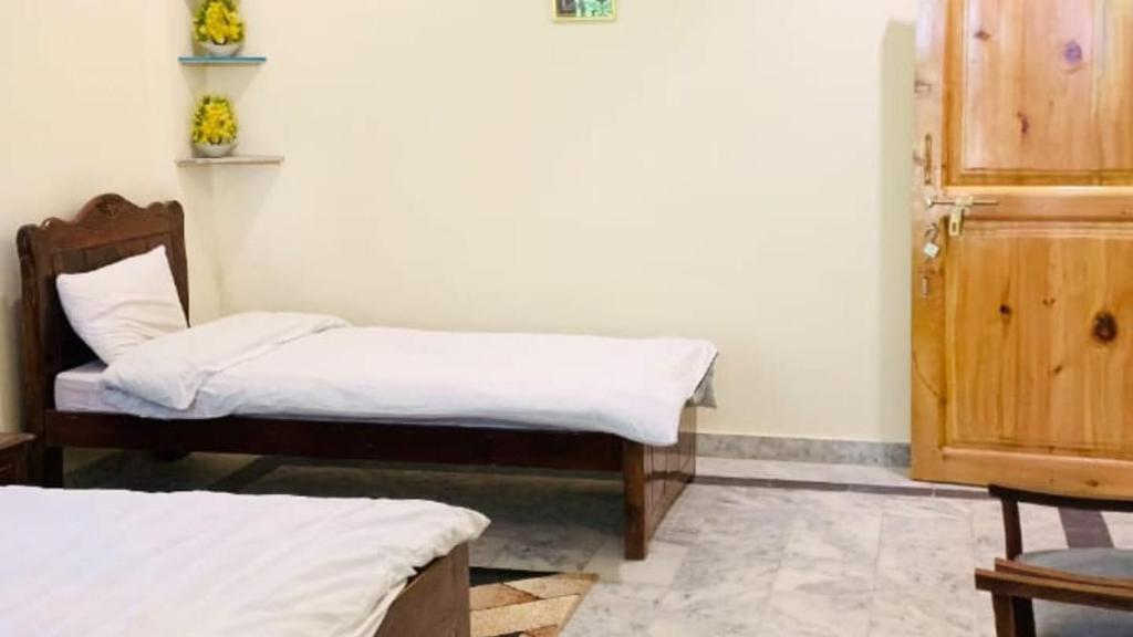 a room with two beds in a room at Eden Garden Resort Batakundi in Naran
