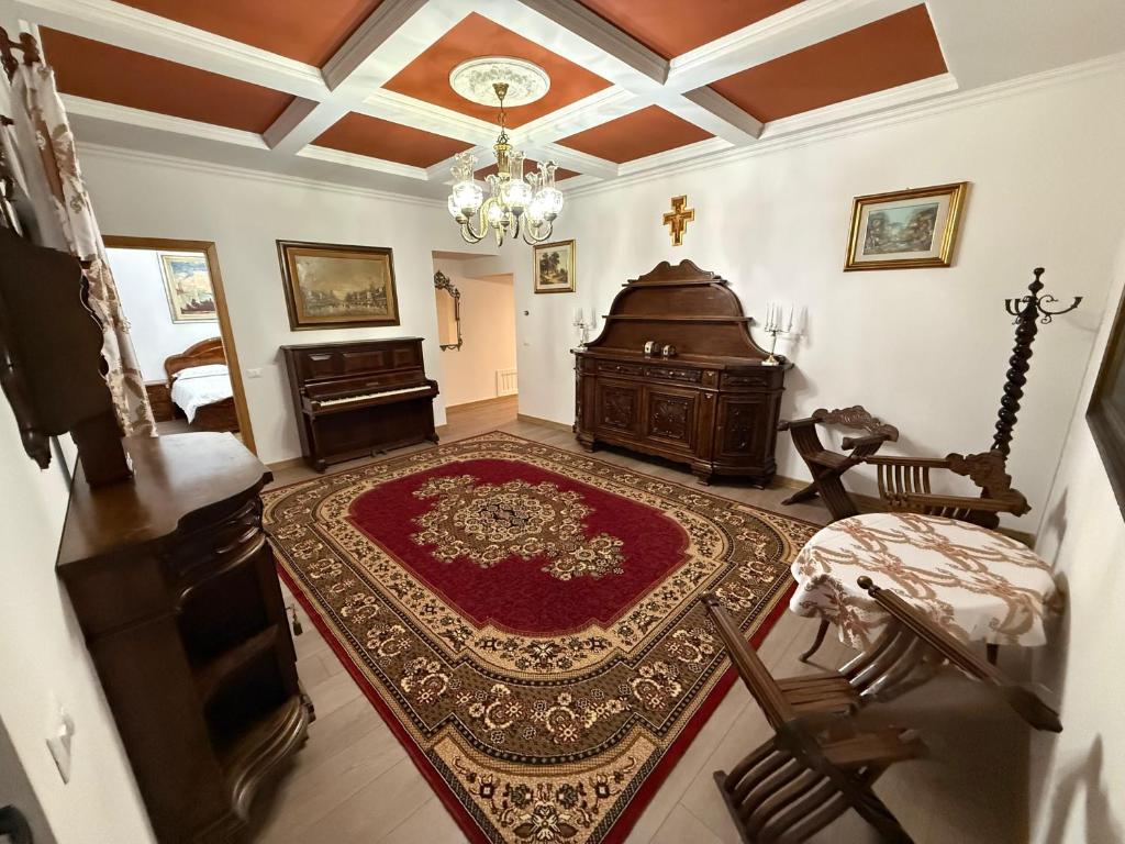a living room with a piano and a red rug at Casa Marza in Făgăraş
