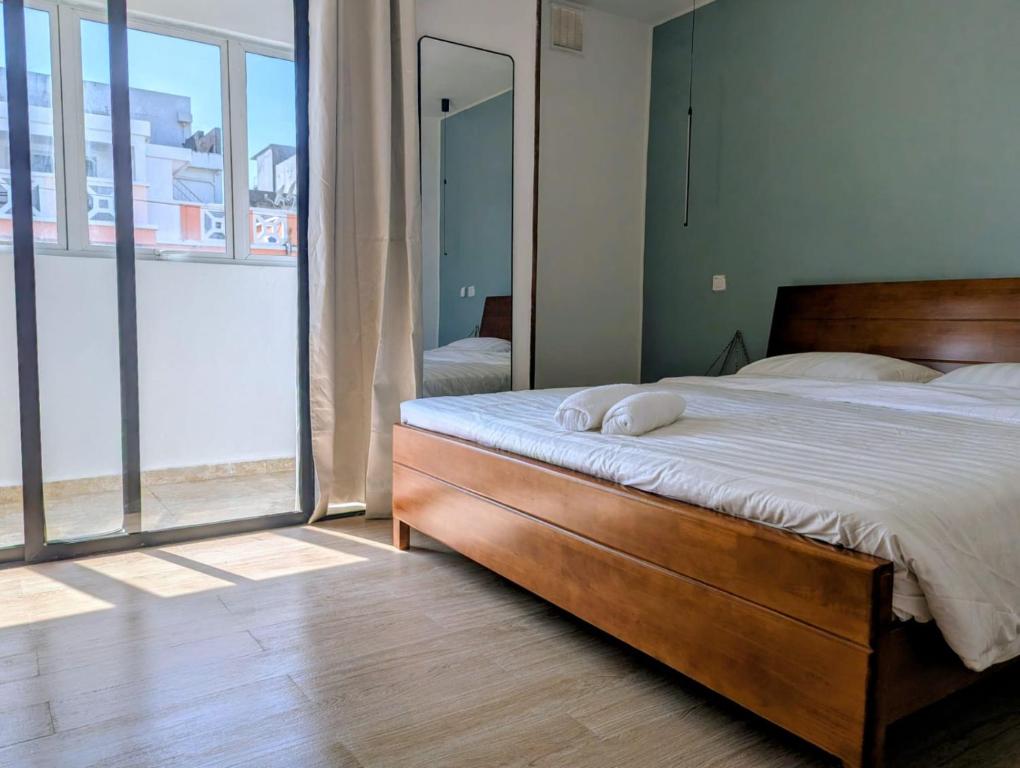 a bedroom with a bed and a large window at OCEAN Hotel Miami in Toamasina