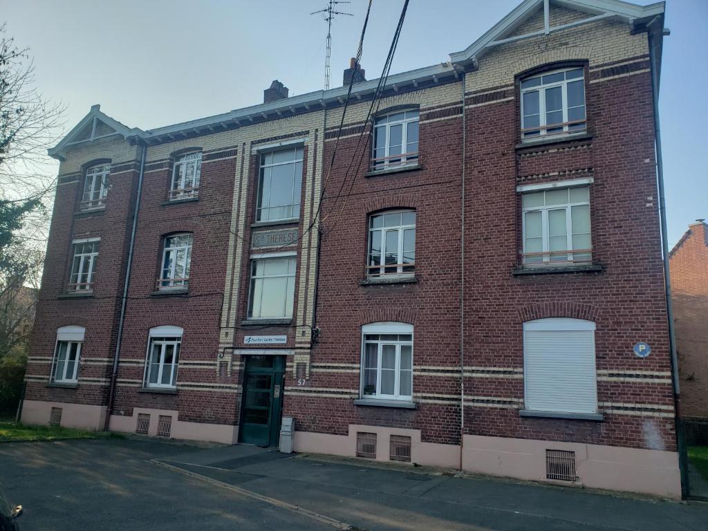 a red brick building with white doors and windows at Cocon lumineux Euratech-CHU in Lille
