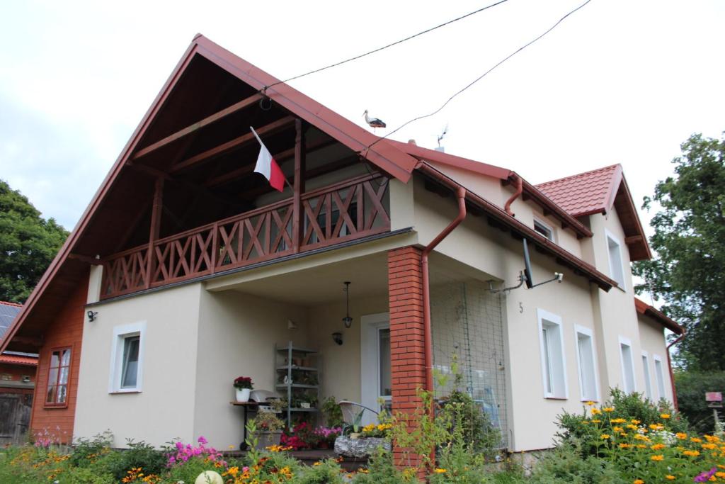 a house with a red roof at Bocianówka 5 in Wężówka