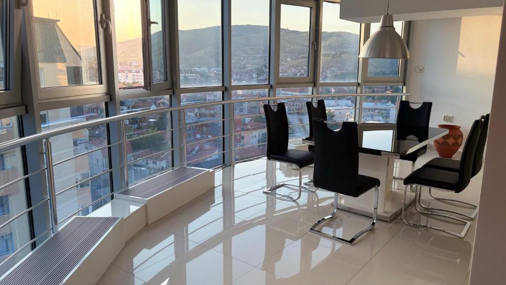 a room with a table and chairs in a building at Matey Luxury Sky Apartment in Bitola