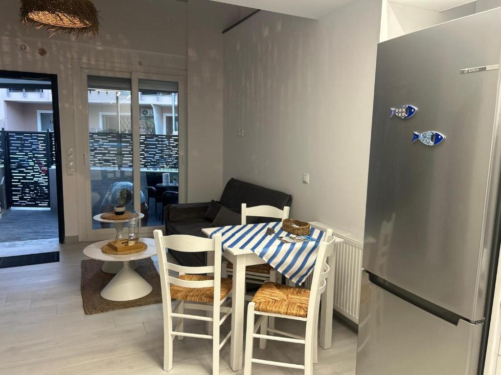 a kitchen with a table and chairs and a refrigerator at Elia Apartments in Eretria