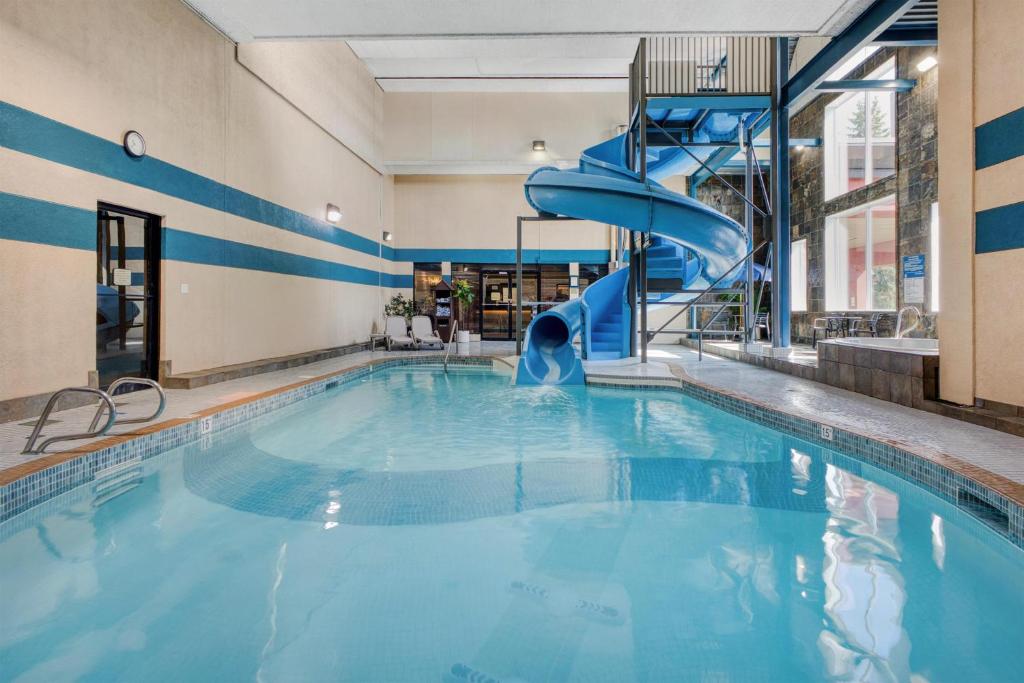a swimming pool with a slide in a building at Best Western PLUS City Centre Inn in Edmonton