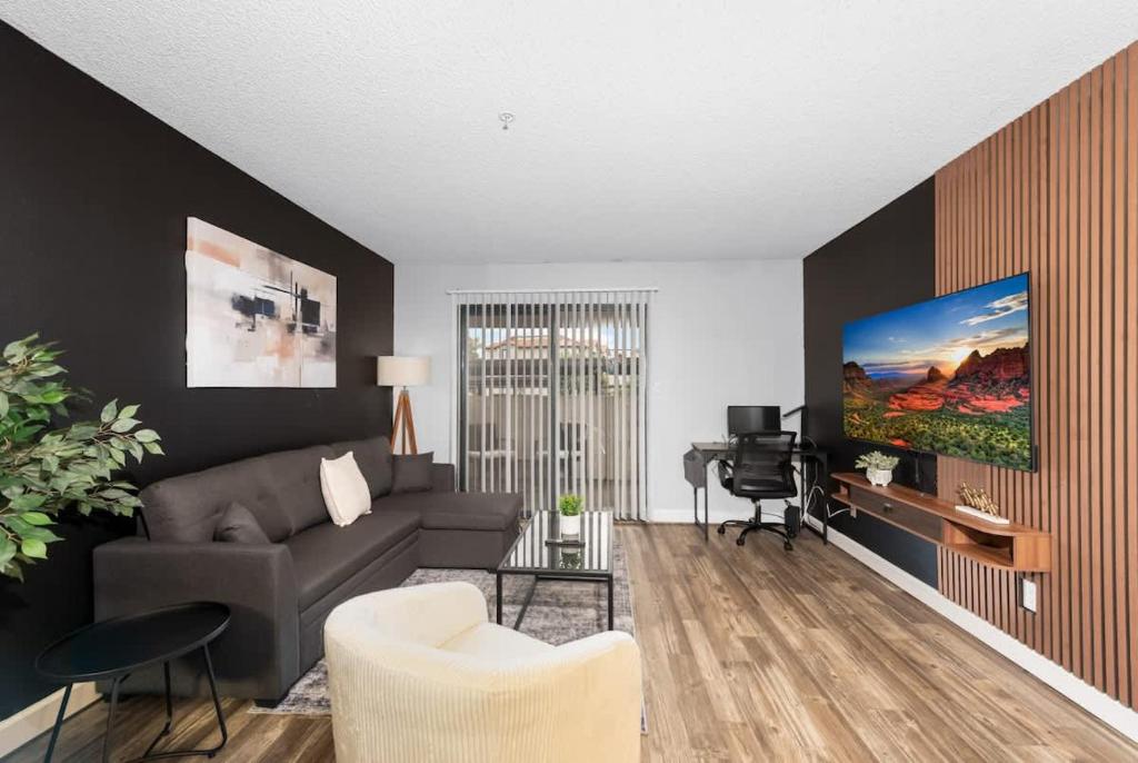 a living room with a couch and a tv at Tempe Hideaway Luxe Amenities Parking in Tempe